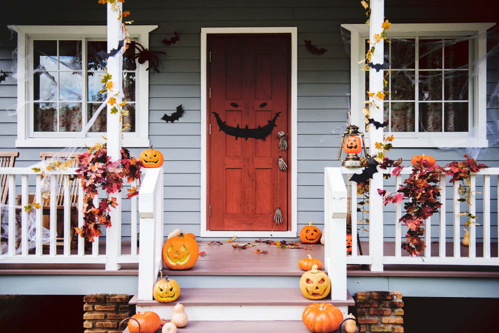 Halloween pumpkins and decorations outside a house