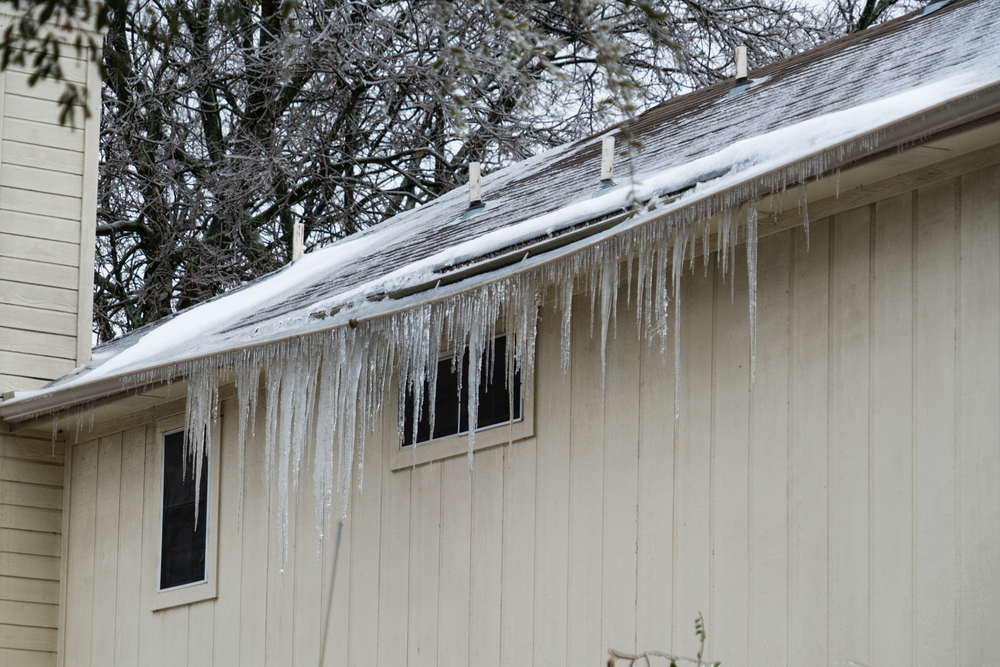 home covered in dangerous huge ice cycles during Extreme Cold Winter Storm